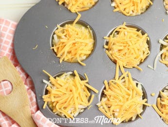 cheese on top of quiche mix in muffin molds