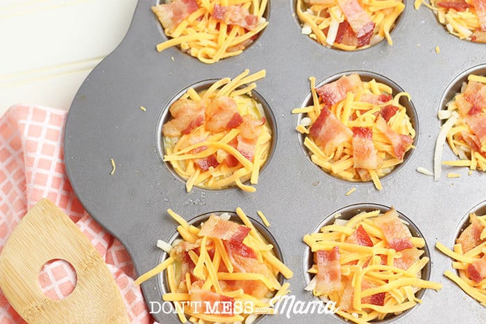 adding bacon to egg mixture in muffin tin 