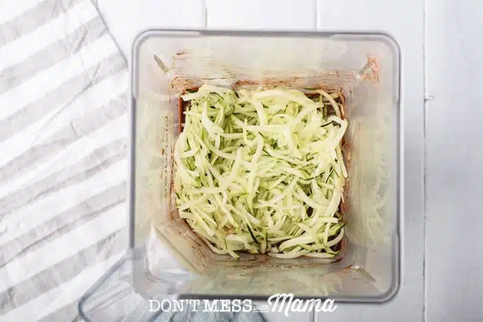 adding shredded zucchini to muffin mix in blender