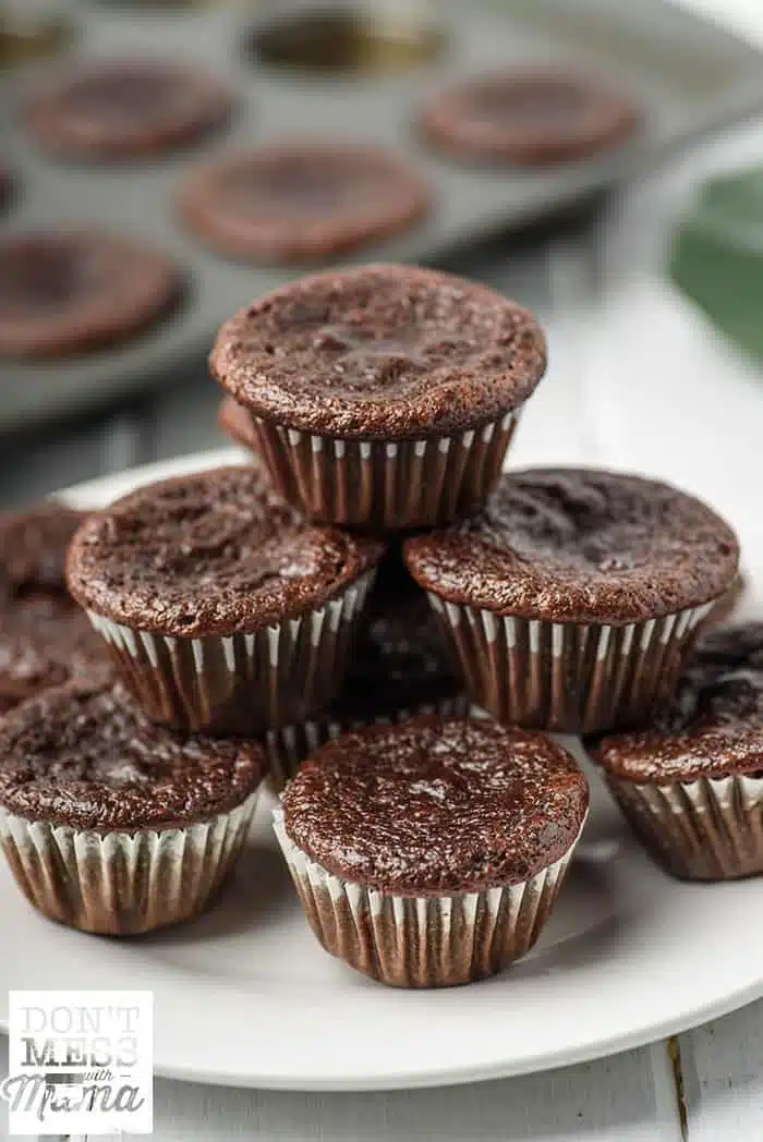 closeup of zucchini chocolate muffins stacked on a plate