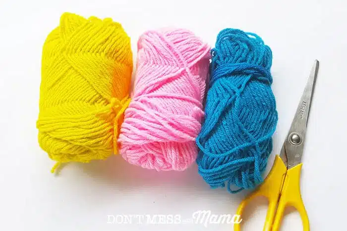 Closeup of yarn and scissors for this friendship bracelet tutorial