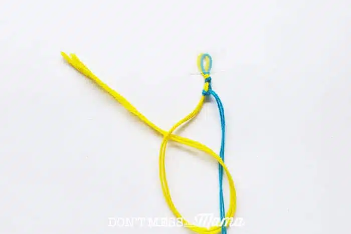 Closeup of string knotted together to make a DIY friendship bracelet