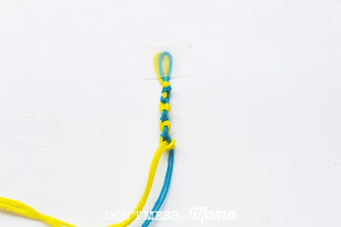 Closeup of blue and yellow string knotted together 