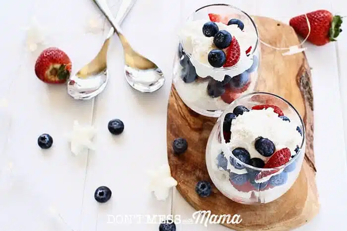 berries and whipped cream in glasses