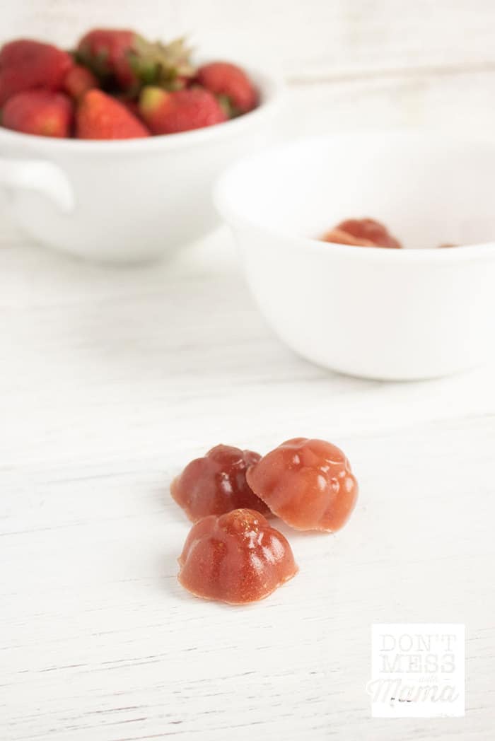 Closeup of homemade healthy fruit snacks with strawberries in the background