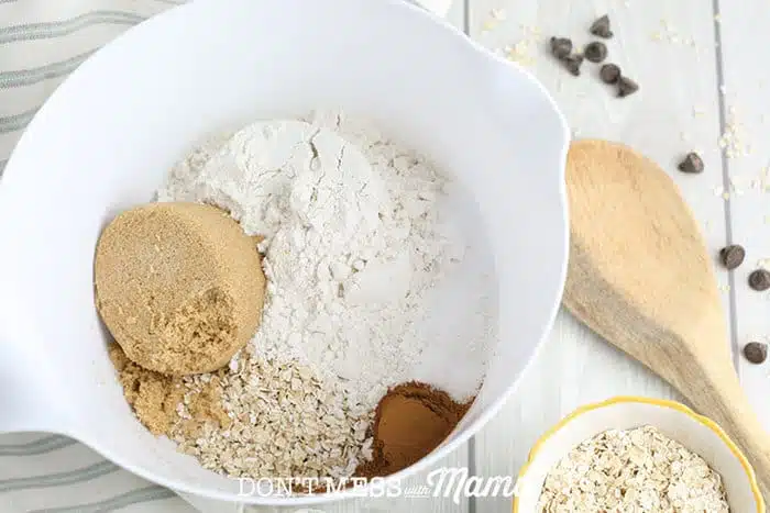 flour, oats, brown sugar in a white bowl on a table