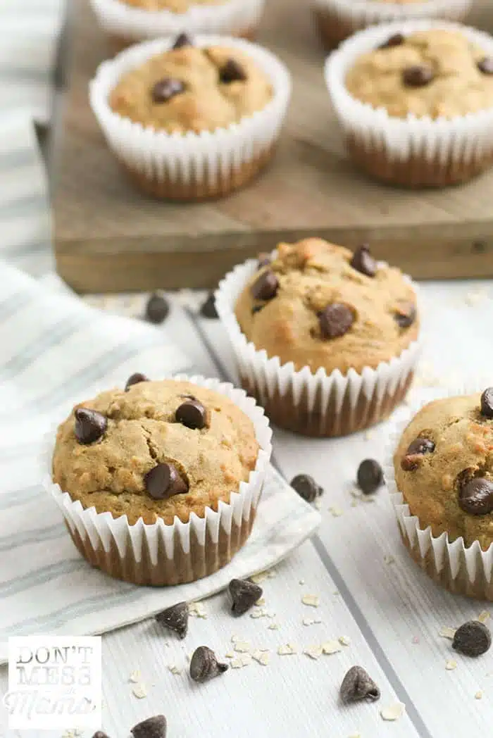 banana chocolate chip muffins on a table and cutting board