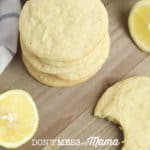 Gluten-Free Lemon Cookies piled on a plate with lemon slices in the background