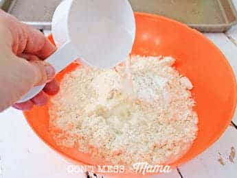 adding water to pizza dough