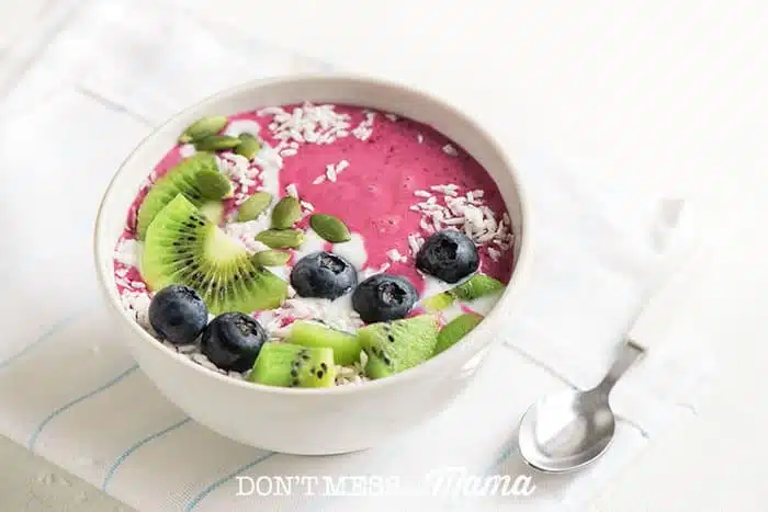 Closeup of smoothie bowl with fresh fruit and spoon