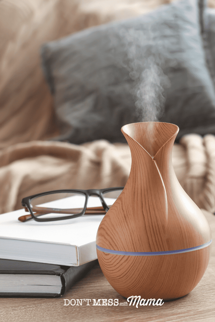 essential oil diffuser with books and glasses