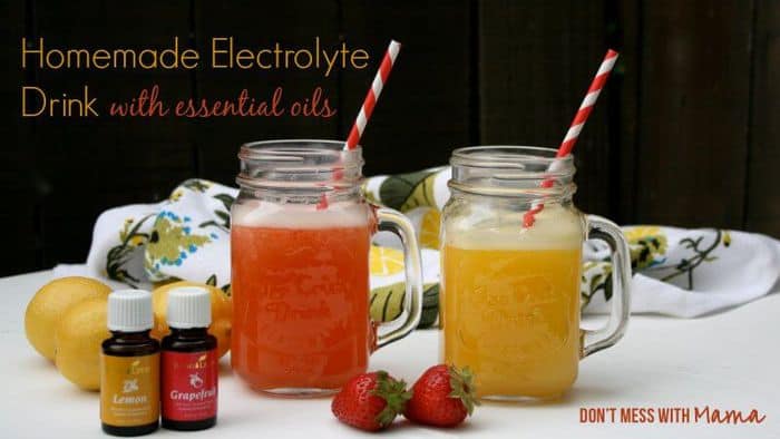 A natural homemade sports drink in two glass jars with essential oils at the side