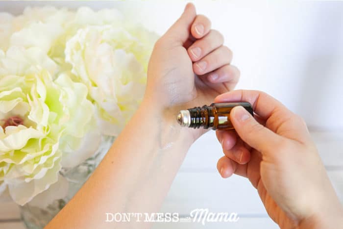 two hands rolling on diy essential oil perfume