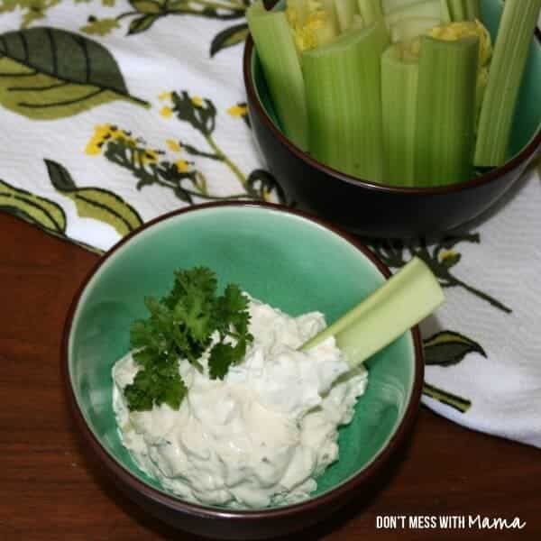 An overhead shot of Homemade Onion Soup Mix and onion dip in a small green bowl with celery