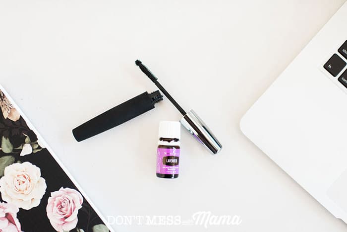 Closeup of lavender essential oils with mascara on a desk