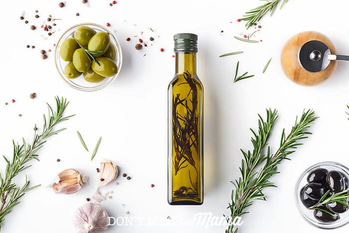 Herb-infused olive oil in a glass bottle