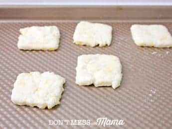 cracker dough squares on baking tray