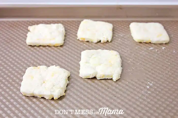 Cheese crackers on parchment paper on a cookie sheet