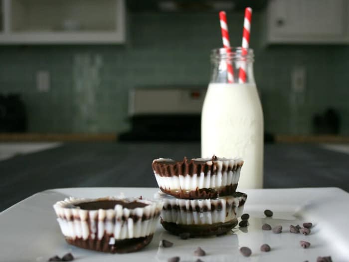chocolate peppermint patties on a white plate with a glass of milk in the background