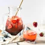 A red sangria recipe in a glass with fruit