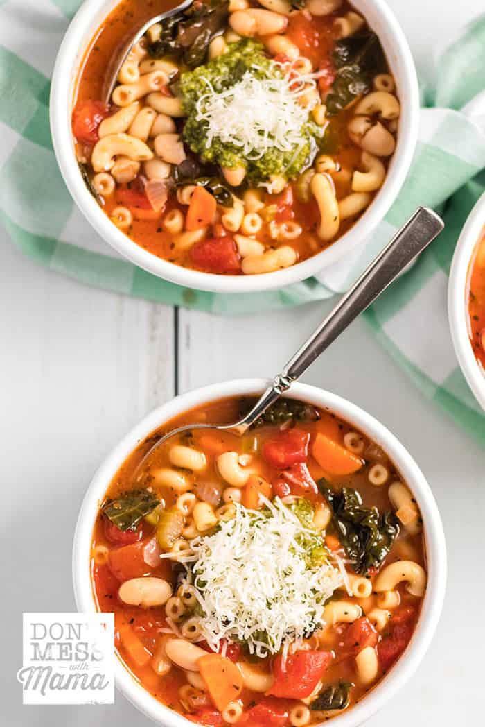 Instant Pot Minestrone soup in two white bowls topped with Parmesan cheese