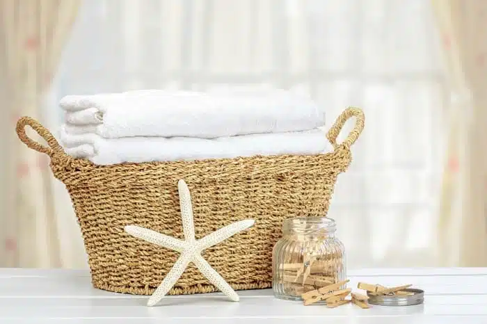 Basket of fresh towels with clothes pins in the background
