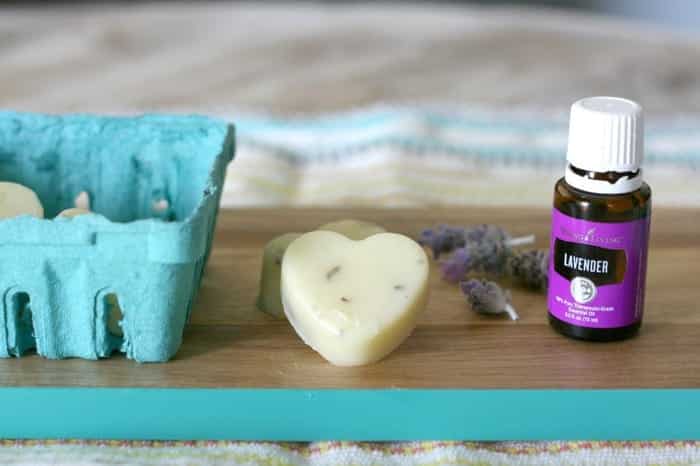 DIY Lotion Bar on a table with a essential oil bottle