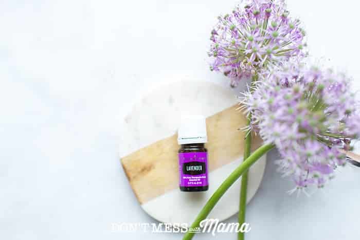 Closeup of lavender essential oil next to a flower