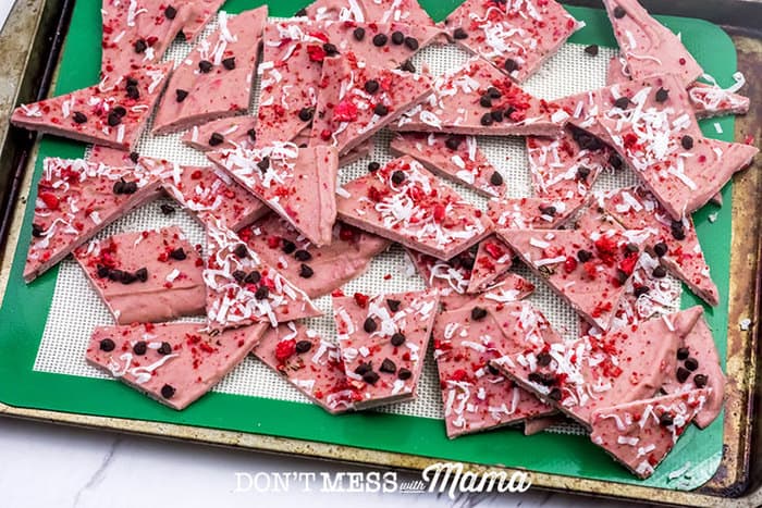 Closeup of strawberry bark frozen and cut into pieces on a cookie sheet