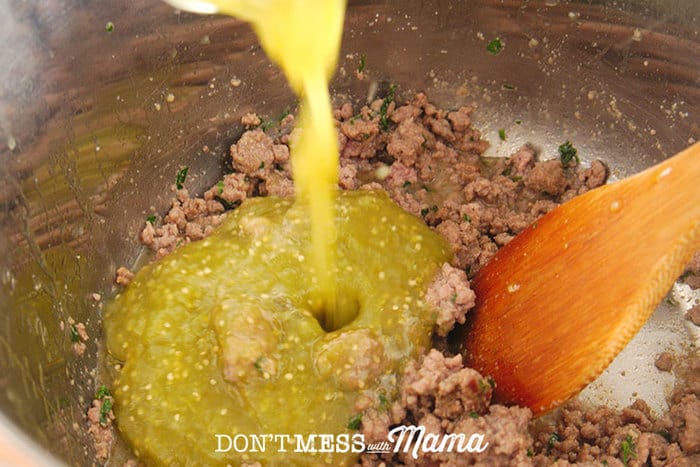 Closeup of salsa verde getting added to ground beef in an Instant Pot
