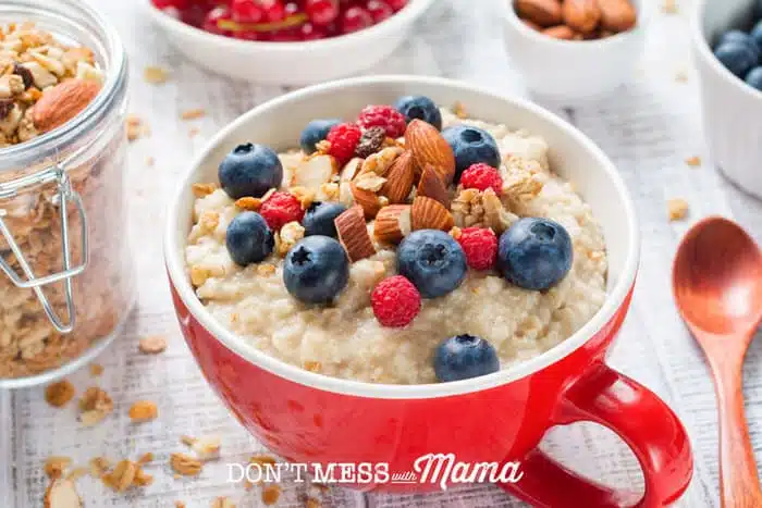a cup with oatmeal and berries