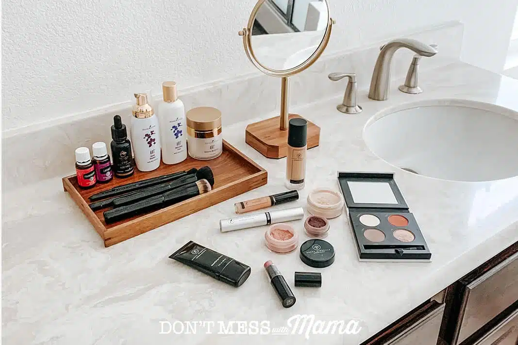 Savvy minerals makeup like lipstick, eye shadow and makeup brushes on a bathroom counter