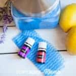 DIY Reusable Cleaning Wipes on a table with essential oils and lemons