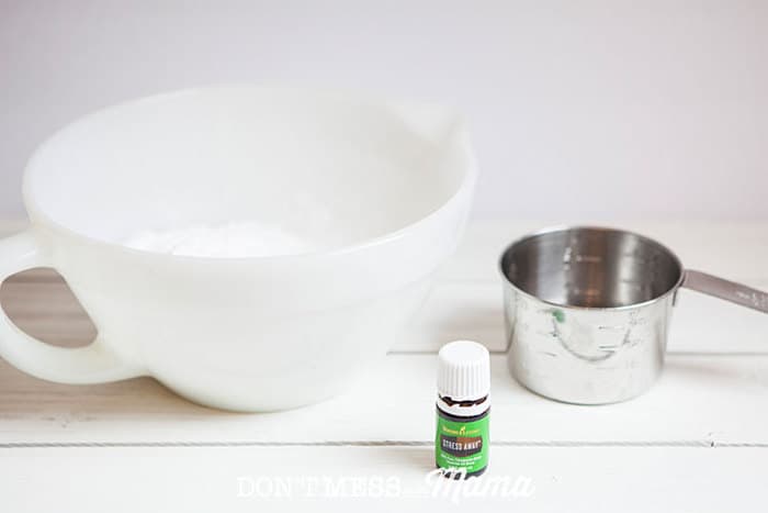 Closeup of mixing bowl, measuring cup and bottle of Stress Away essential oil