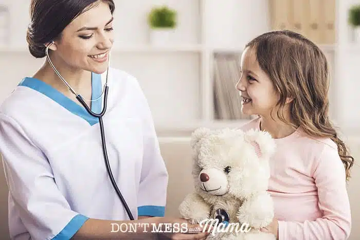 Closeup of nurse with a stethoscope and a young girl