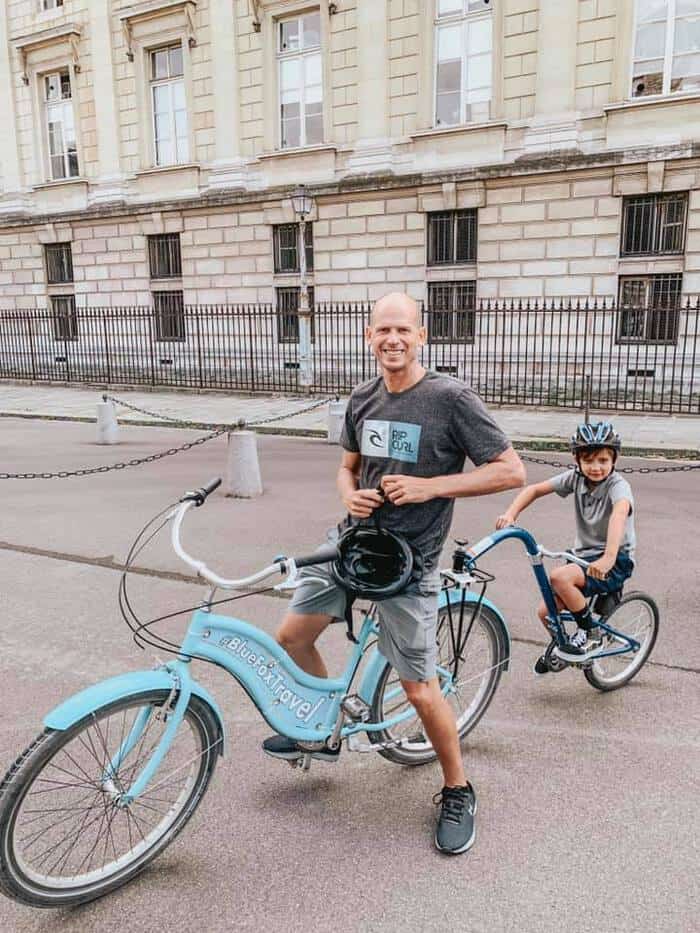 father and son on bikes in paris