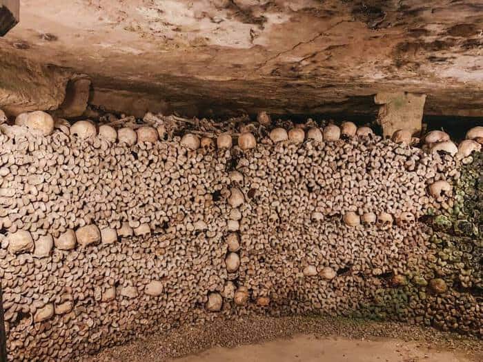 a wall of bones in the catacombs in Paris 