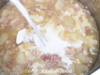 pouring half and half into clam chowder