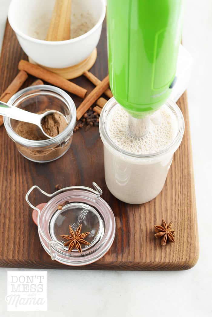 Immersion blender in a glass of vanilla chai latte