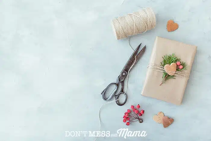 top down shot of scissors, string and a package on a table