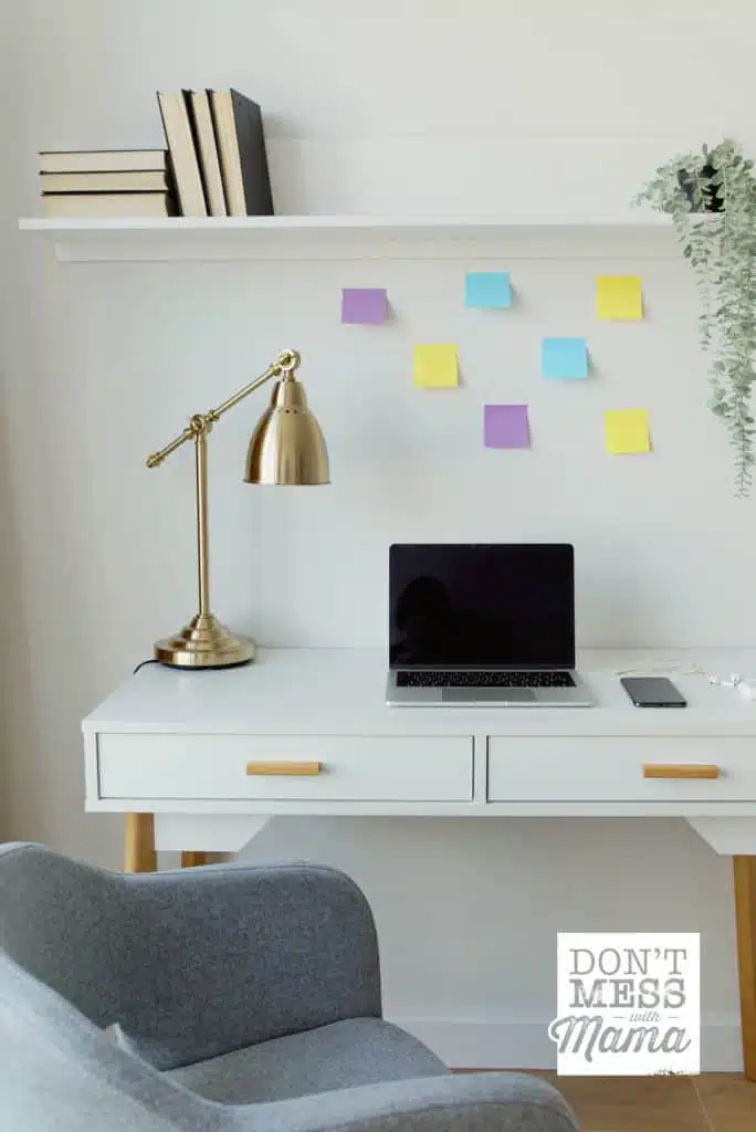 minimalist desk with lamp and sticky notes