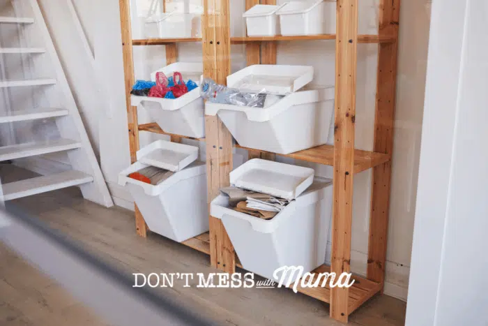 white bins on shelves with recycling organized
