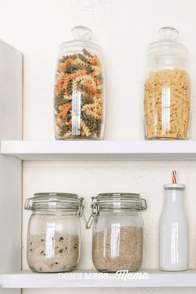 pantry shelf with rice and pasta in jars