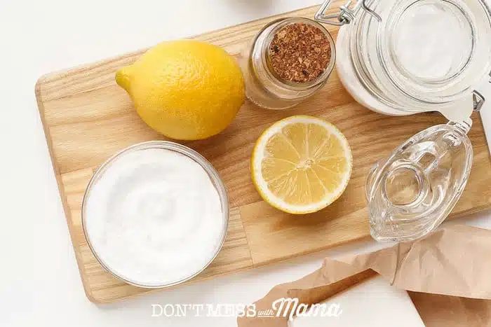 baking soda, lemons, vinegar on a table - natural cleaning ingredients