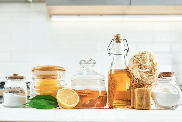baking soda, lemons, vinegar, on a table for natural cleaning
