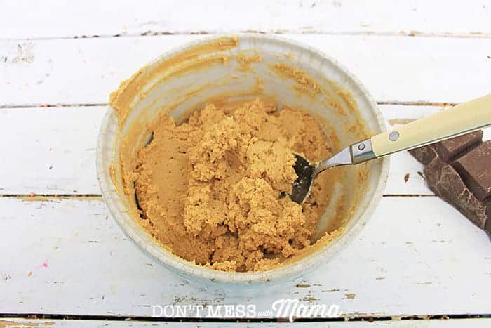 mixing peanut butter and cream cheese in a white bowl