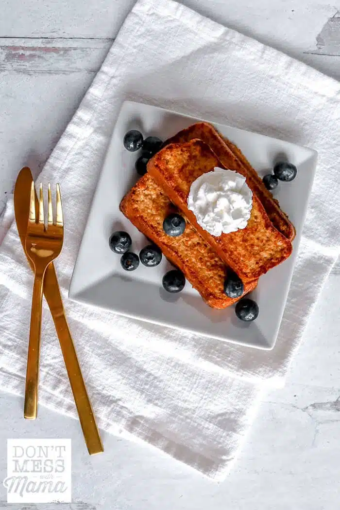 Keto french toast on a white plate with blueberries