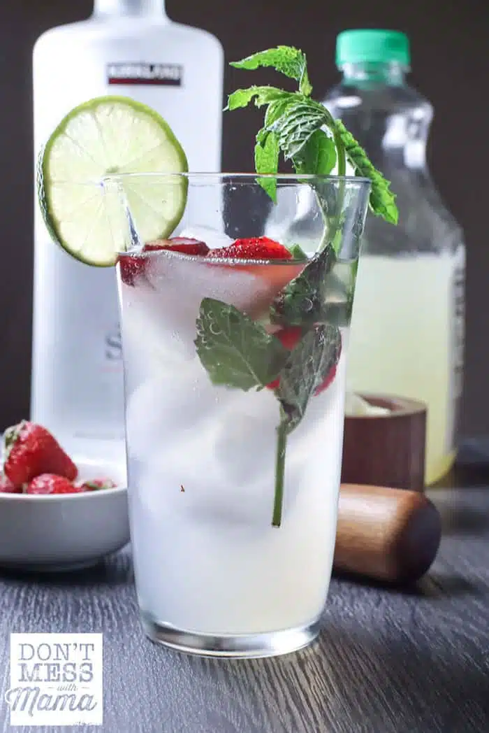 moscow mule in a tall glass with strawberries, lime and mint