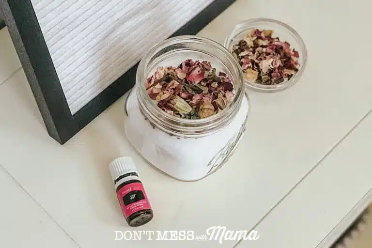 open jar of bath bomb fizzies with dried rose petals