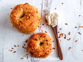 two onion bagels with spoon of cream cheese